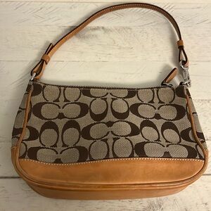 Coach leather/signature fabric wristlet/clutch. 9 1/2“ x 5 1/4“ x 2“ tan/brown